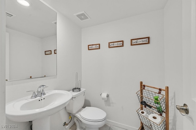 bathroom featuring tile patterned floors, toilet, and sink