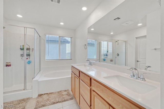 bathroom featuring tile patterned flooring, vanity, and plus walk in shower