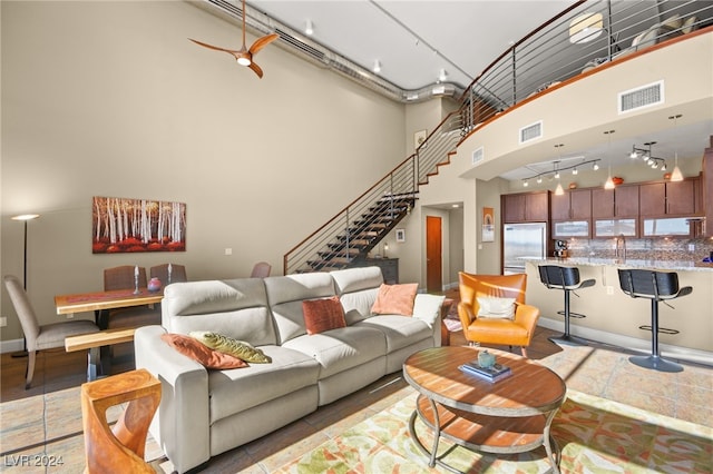 tiled living room with a high ceiling