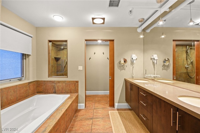 bathroom with shower with separate bathtub, vanity, and tile patterned floors