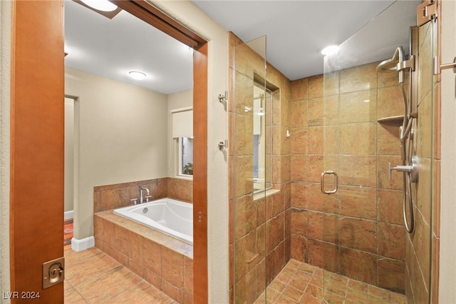 bathroom featuring independent shower and bath