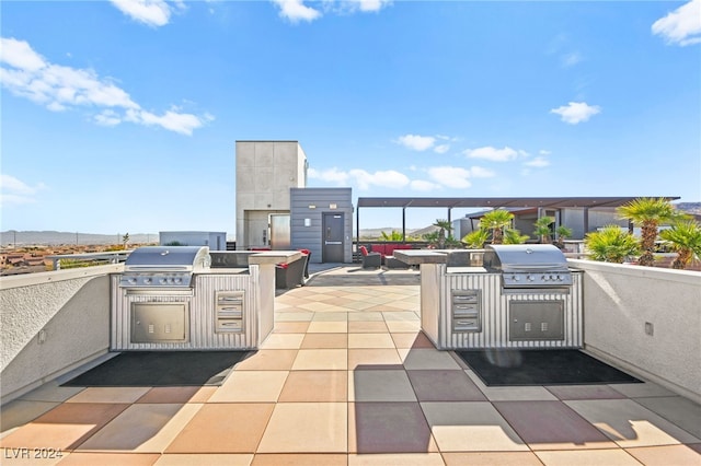 view of patio with area for grilling, outdoor lounge area, and exterior kitchen