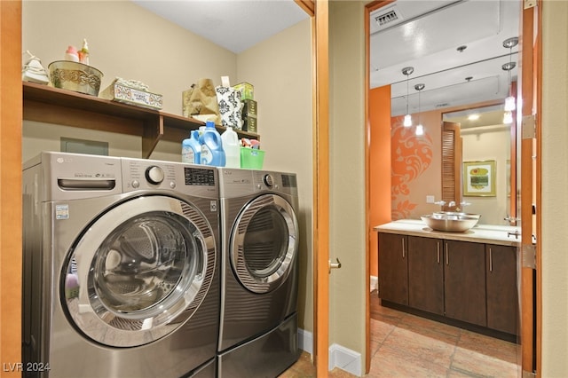 laundry room featuring separate washer and dryer and sink