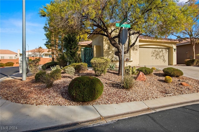 498 Canyon View Way, Mesquite, NV 89027 - view of front of home with stucco siding, driveway, a garage, and a tile roof