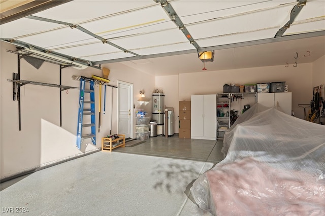 garage with water heater and a garage door opener