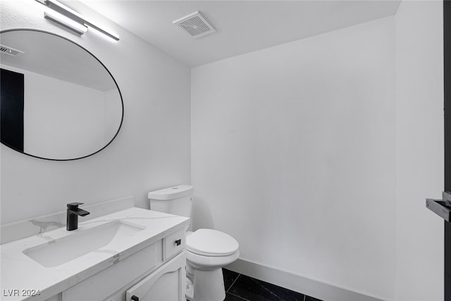 bathroom featuring tile patterned flooring, vanity, and toilet