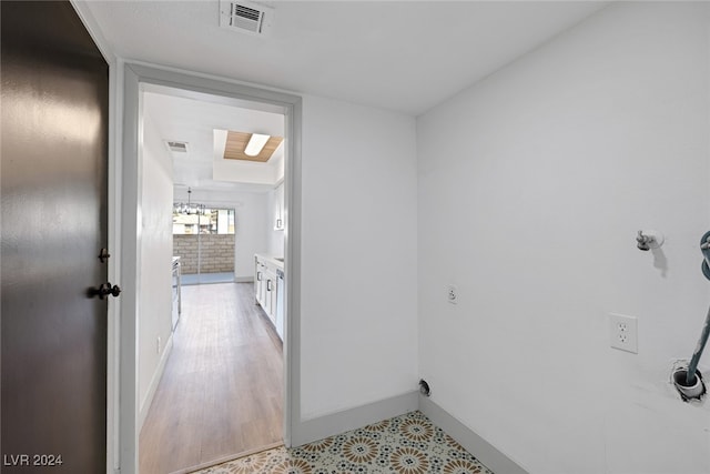 interior space featuring light hardwood / wood-style flooring and a notable chandelier