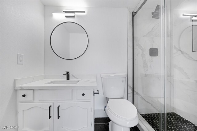 bathroom featuring vanity, toilet, and walk in shower