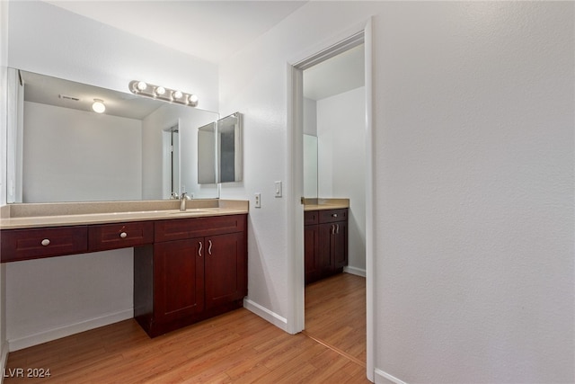 bathroom featuring vanity and wood-type flooring