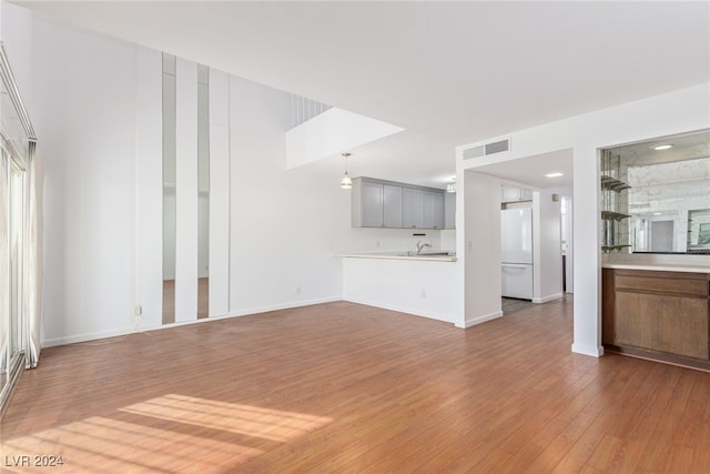 unfurnished living room with hardwood / wood-style floors