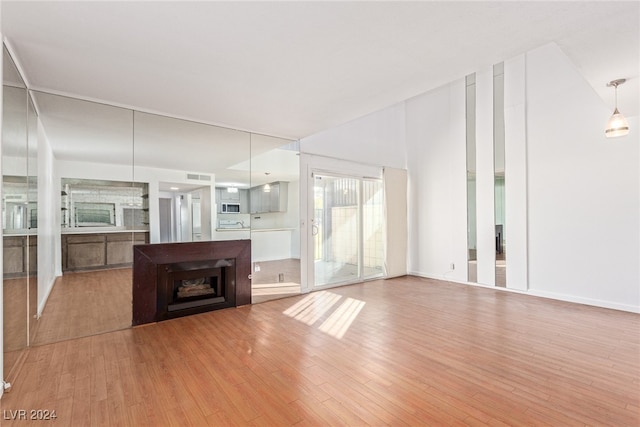 unfurnished living room featuring a fireplace and light wood-type flooring