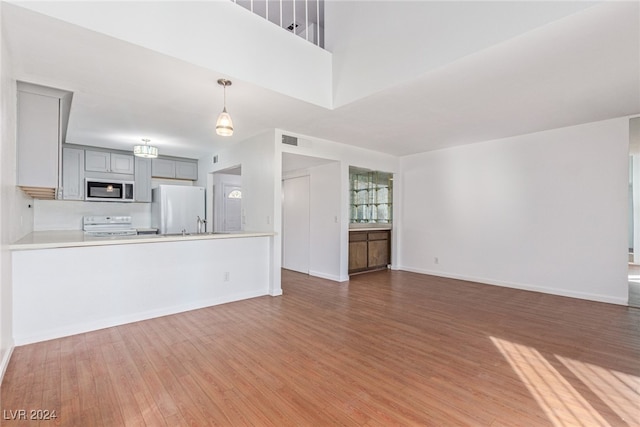 unfurnished living room featuring hardwood / wood-style floors