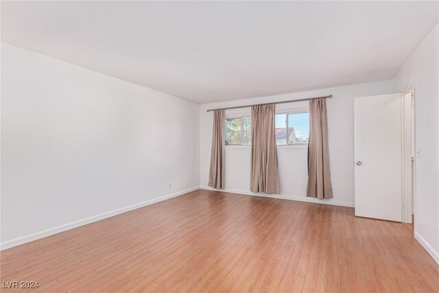 unfurnished room with light hardwood / wood-style floors