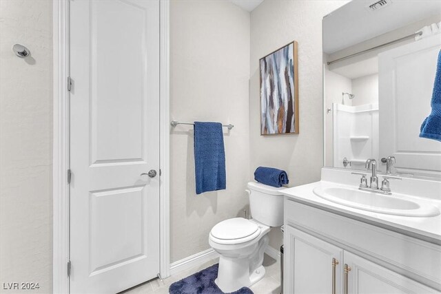 bathroom with toilet, walk in shower, tile patterned floors, and vanity