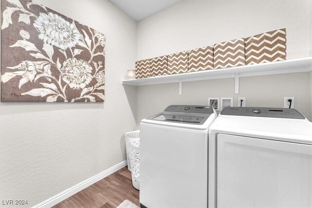 laundry area with separate washer and dryer and wood-type flooring