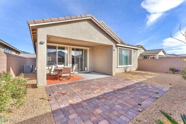 back of property featuring a patio area and central AC