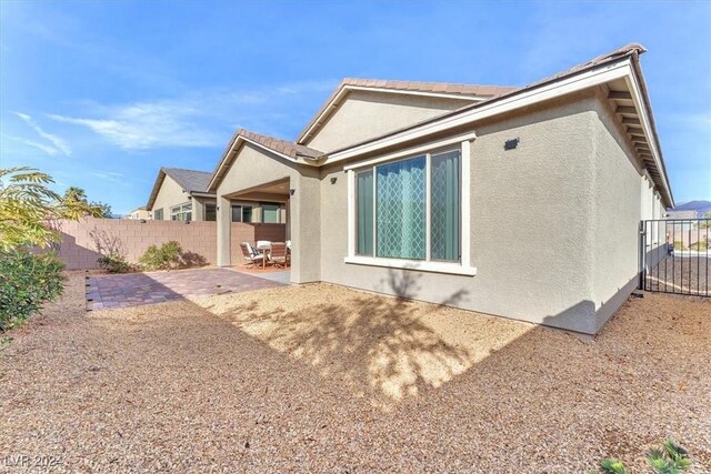 rear view of house featuring a patio