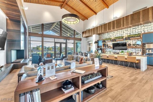 living room with wooden ceiling, light hardwood / wood-style floors, beamed ceiling, and high vaulted ceiling