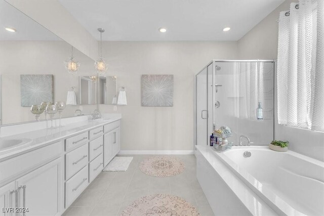 bathroom with tile patterned floors, vanity, and shower with separate bathtub