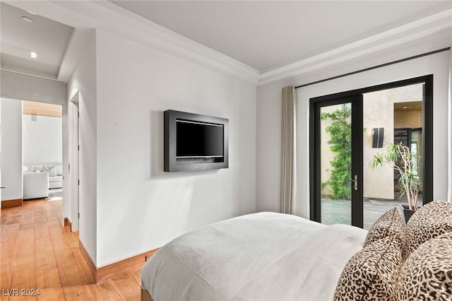 bedroom featuring access to exterior and light hardwood / wood-style flooring