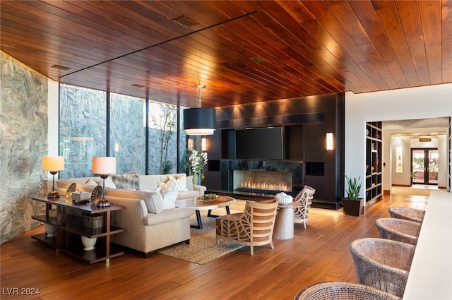 living room featuring hardwood / wood-style floors, plenty of natural light, and wood ceiling