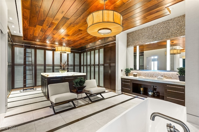 bathroom with tile patterned floors, vanity, wood ceiling, and a tub to relax in