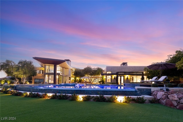 pool at dusk with a yard