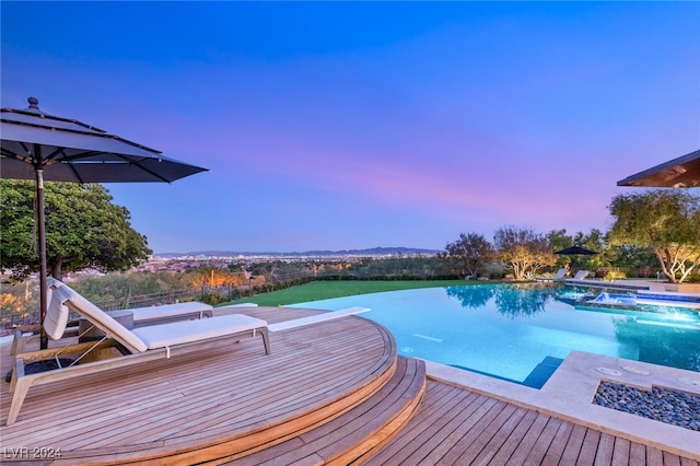 pool at dusk with a deck