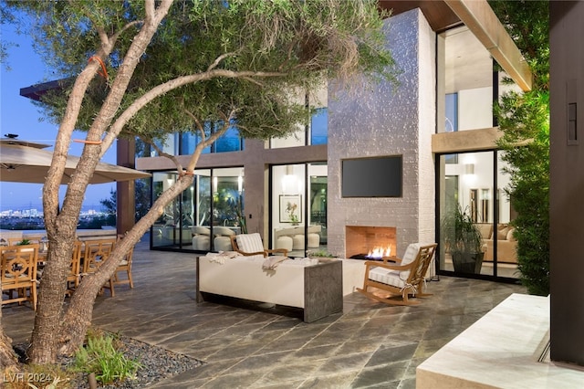 view of patio / terrace with an outdoor living space with a fireplace