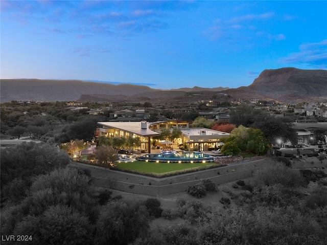 aerial view at dusk featuring a mountain view