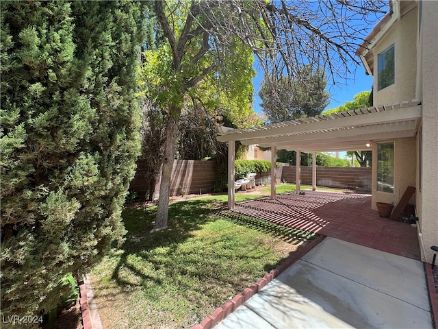 view of yard with a pergola and a patio