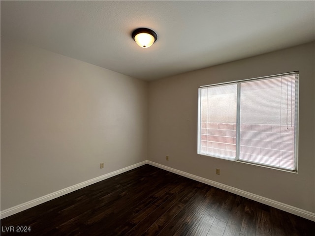 spare room with dark wood-type flooring