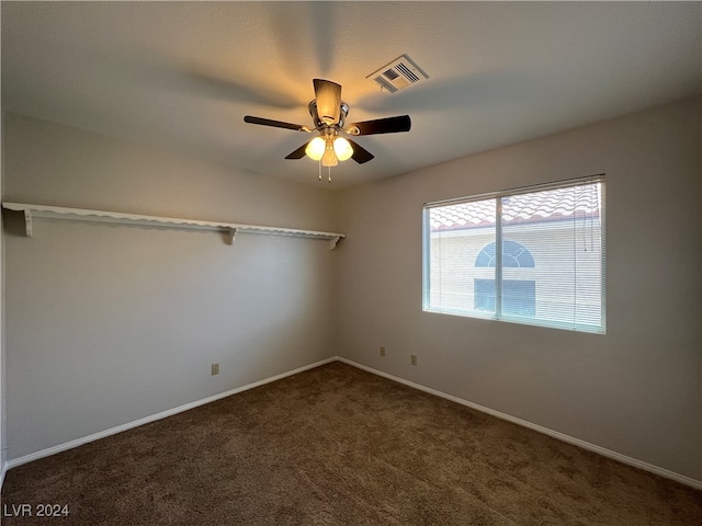 carpeted spare room with ceiling fan