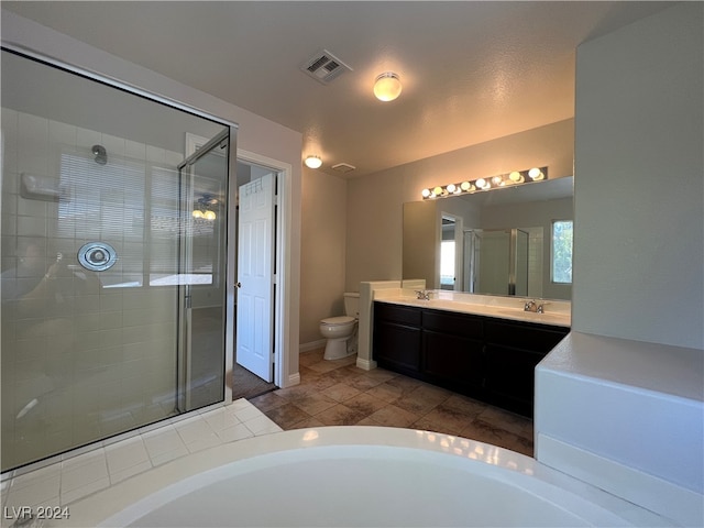 bathroom featuring vanity, toilet, and a shower with door