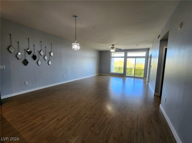 empty room featuring ceiling fan and dark wood-type flooring