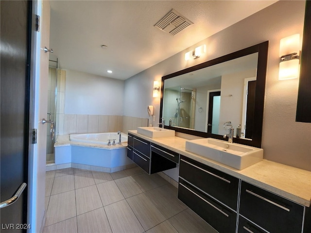 bathroom featuring tile patterned floors, vanity, and independent shower and bath