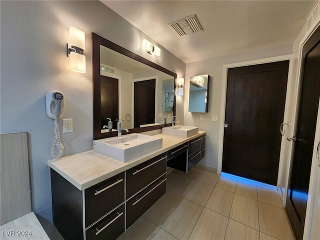 bathroom featuring tile patterned flooring and vanity