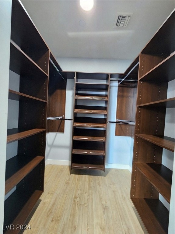 walk in closet featuring light hardwood / wood-style flooring