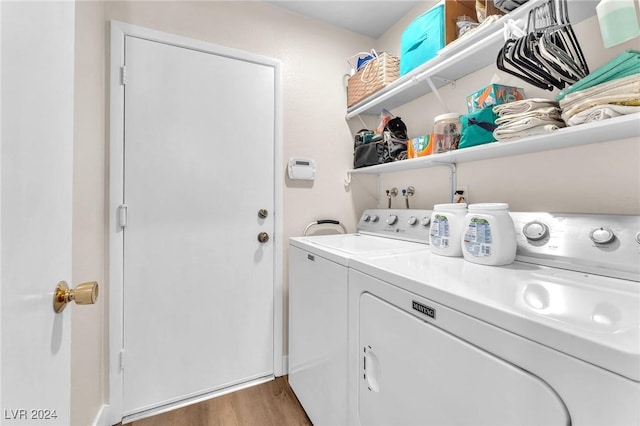 laundry room with washer and clothes dryer and dark hardwood / wood-style flooring