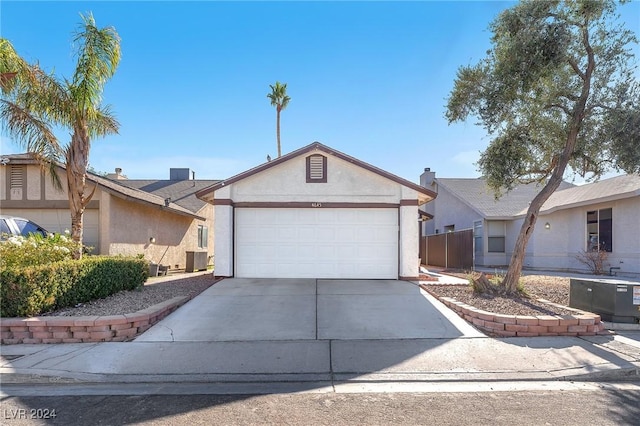 single story home with central AC and a garage