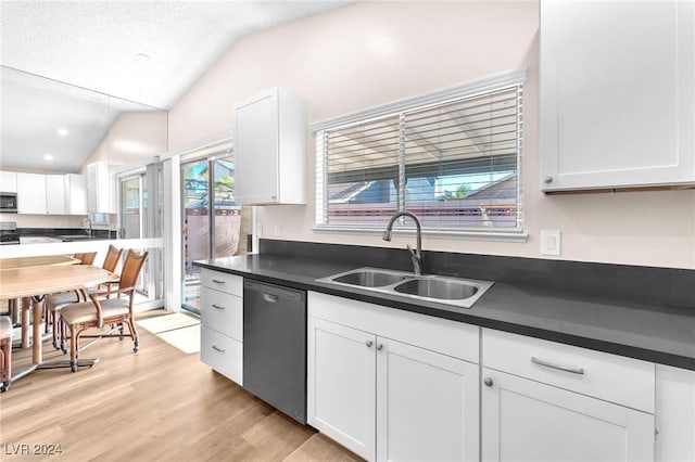 kitchen featuring sink, white cabinets, stainless steel appliances, and lofted ceiling