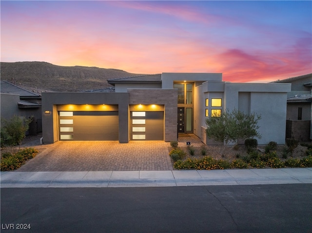 contemporary house with a mountain view and a garage