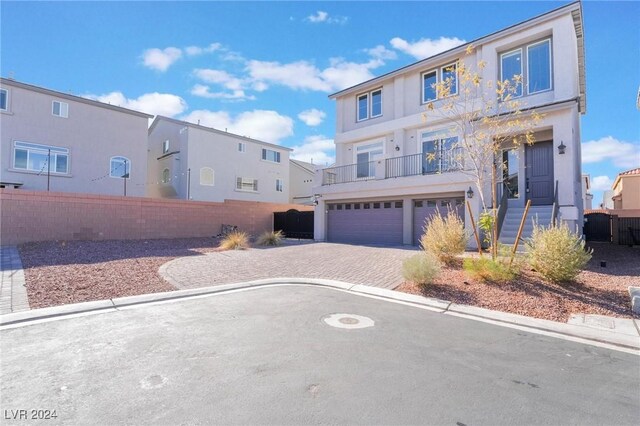 view of front of home with a balcony and a garage