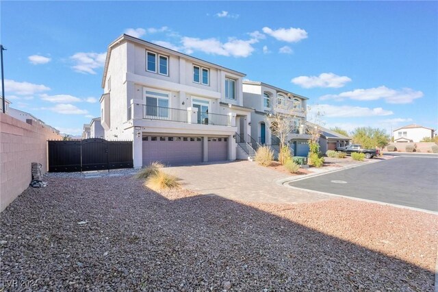 view of front of property featuring a balcony and a garage