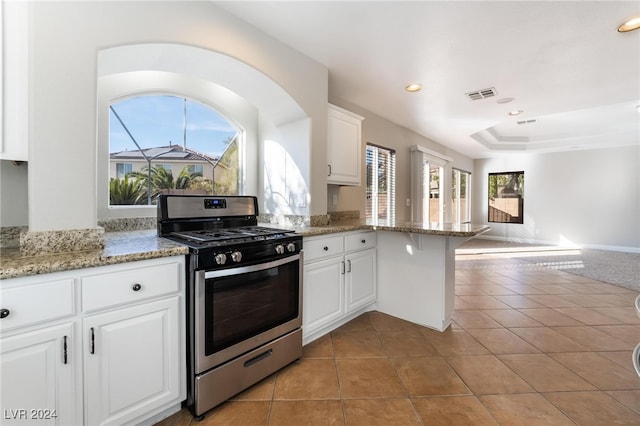 kitchen with plenty of natural light, white cabinetry, light stone countertops, and stainless steel range with gas cooktop