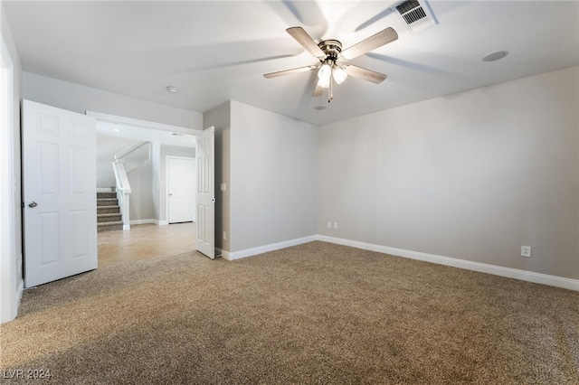 carpeted spare room with ceiling fan