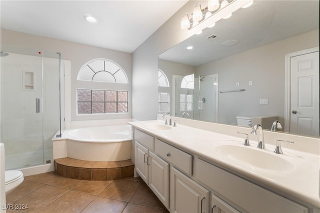 full bathroom featuring tile patterned floors, vanity, plus walk in shower, and toilet