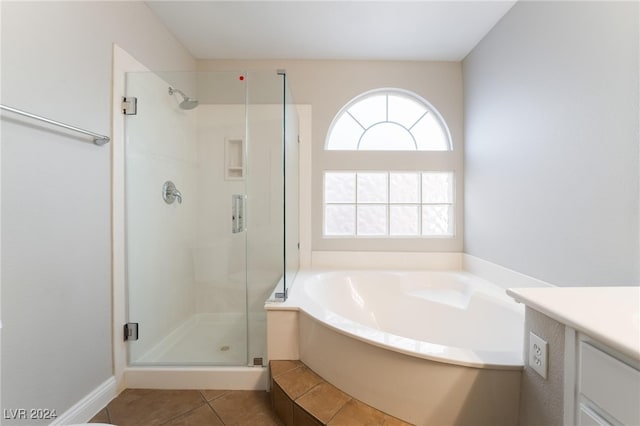 bathroom with tile patterned floors, vanity, and plus walk in shower