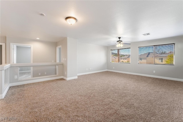 spare room with carpet flooring and ceiling fan