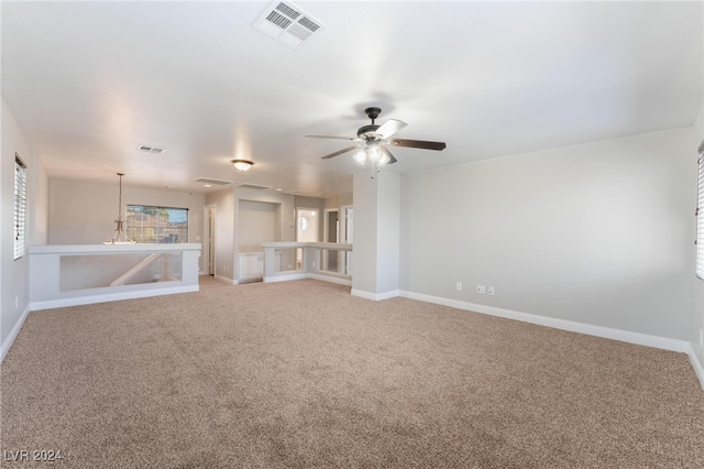 unfurnished living room featuring carpet and ceiling fan